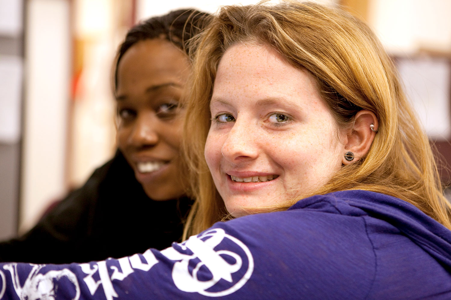 Two young women smile for the camera