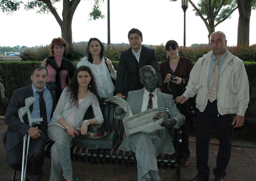 Azerbaijani delegation posing with bronze statue in the park