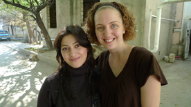 Two young women smile for the camera