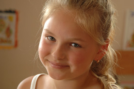 Young girl smiles for the camera.