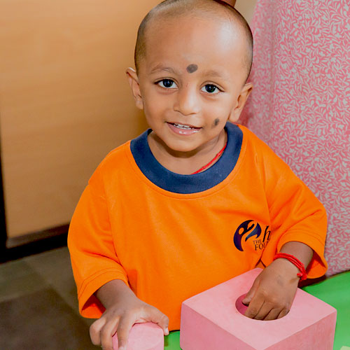 Young child smiles for the camera.