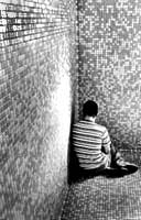 Young boy in corner of shower