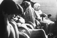 People sitting on chairs in day room