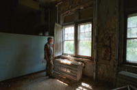 Dennis Felty looking out window of children's ward at Pennhurst