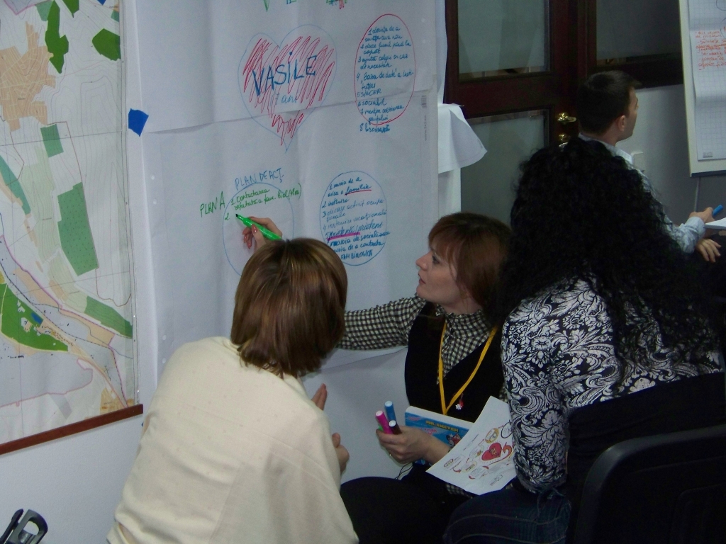 People working together on a wall chart during a workshop